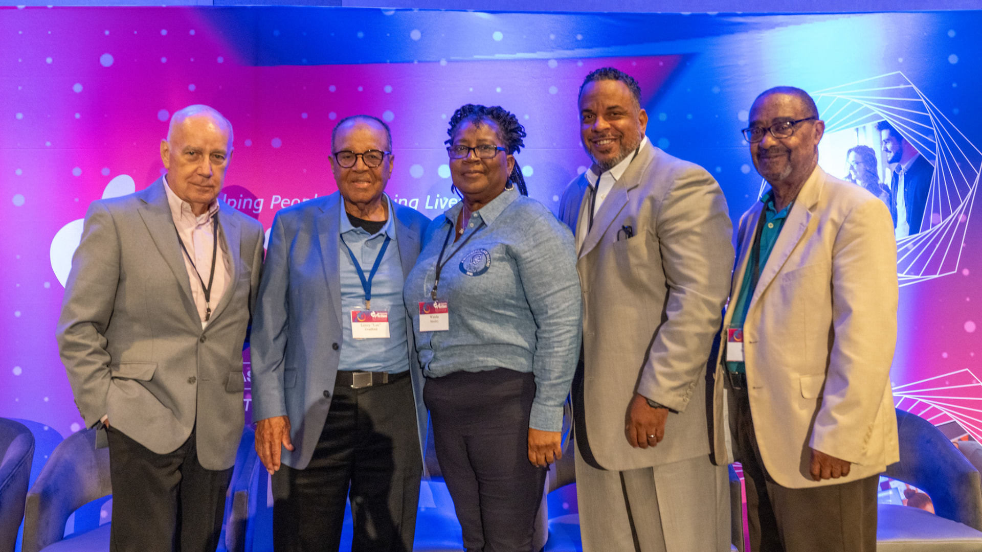 Five Community Action leaders gathered at a conference