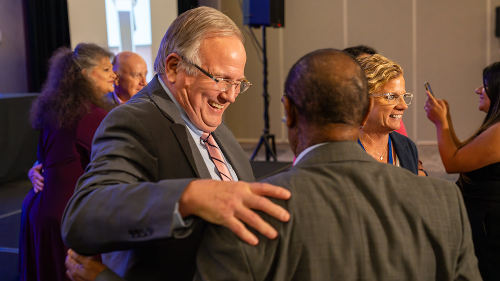 An award recipient shaking hands on stage during the awards celebration